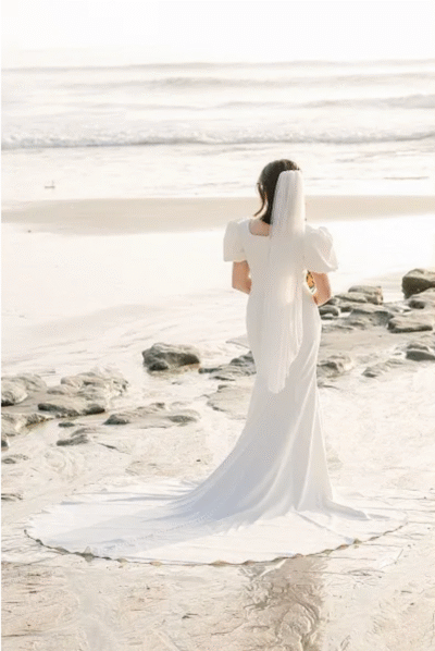 bride-walking-alone-on-southern-california-beach